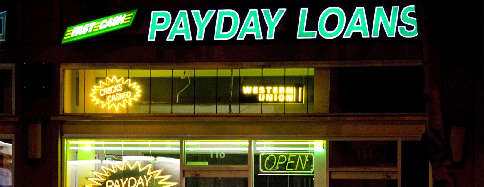 Signs in the window of a payday lending business